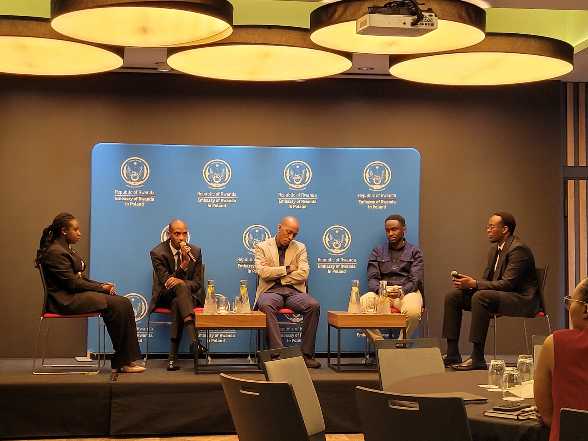 Panel discussion on stage with embassy representatives and community members in Kraków